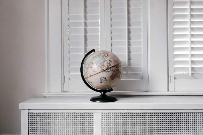 World globe on a desk under a window 