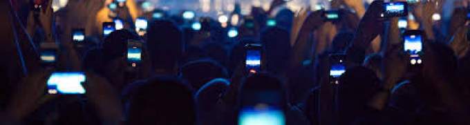 People at a concert recording the show with phones 