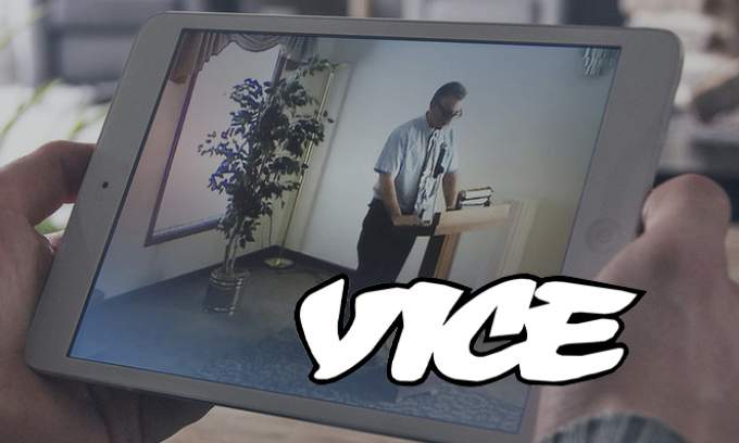 A person holding a tablet watching a celebrant speak at funeral service in a funeral home on the OneRoom platform 